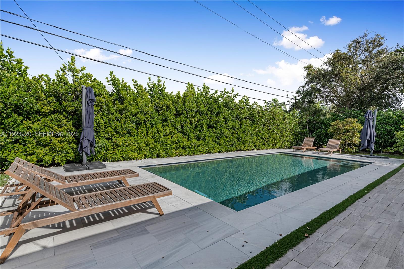 7235 Southwest 39th Street Miami, FL 33155 - Photo 26 of 30 a view of a swimming pool with a patio