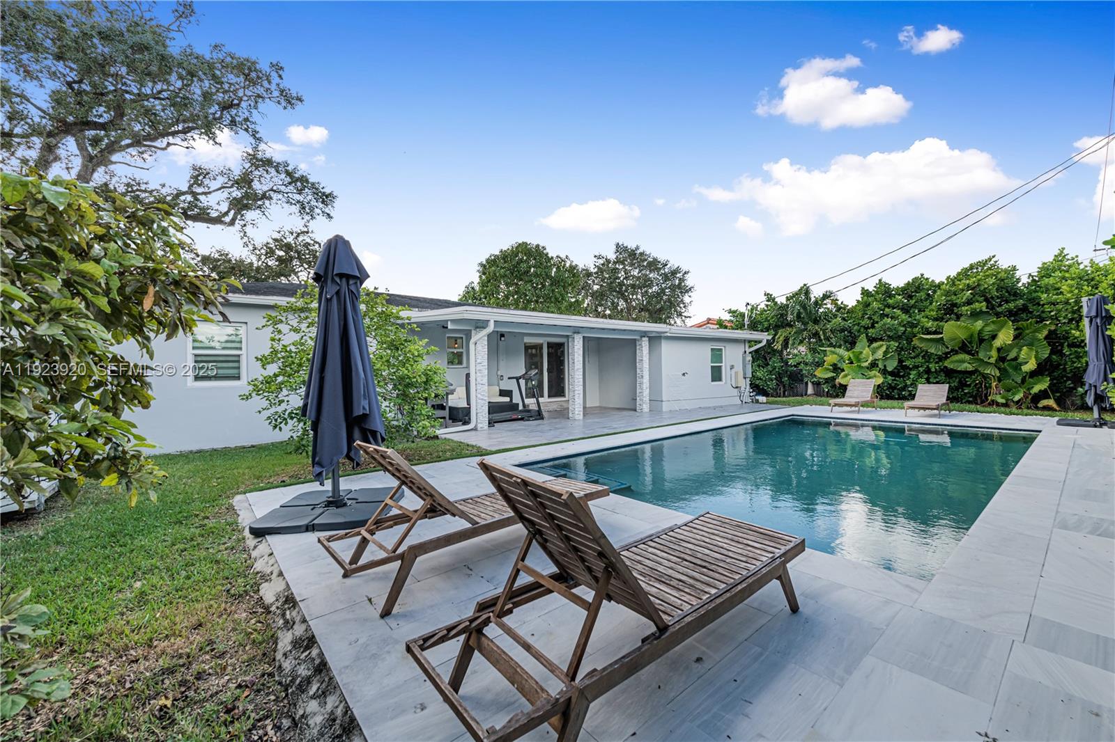7235 Southwest 39th Street Miami, FL 33155 - Photo 3 of 30 a view of a house with backyard sitting area and swimming pool