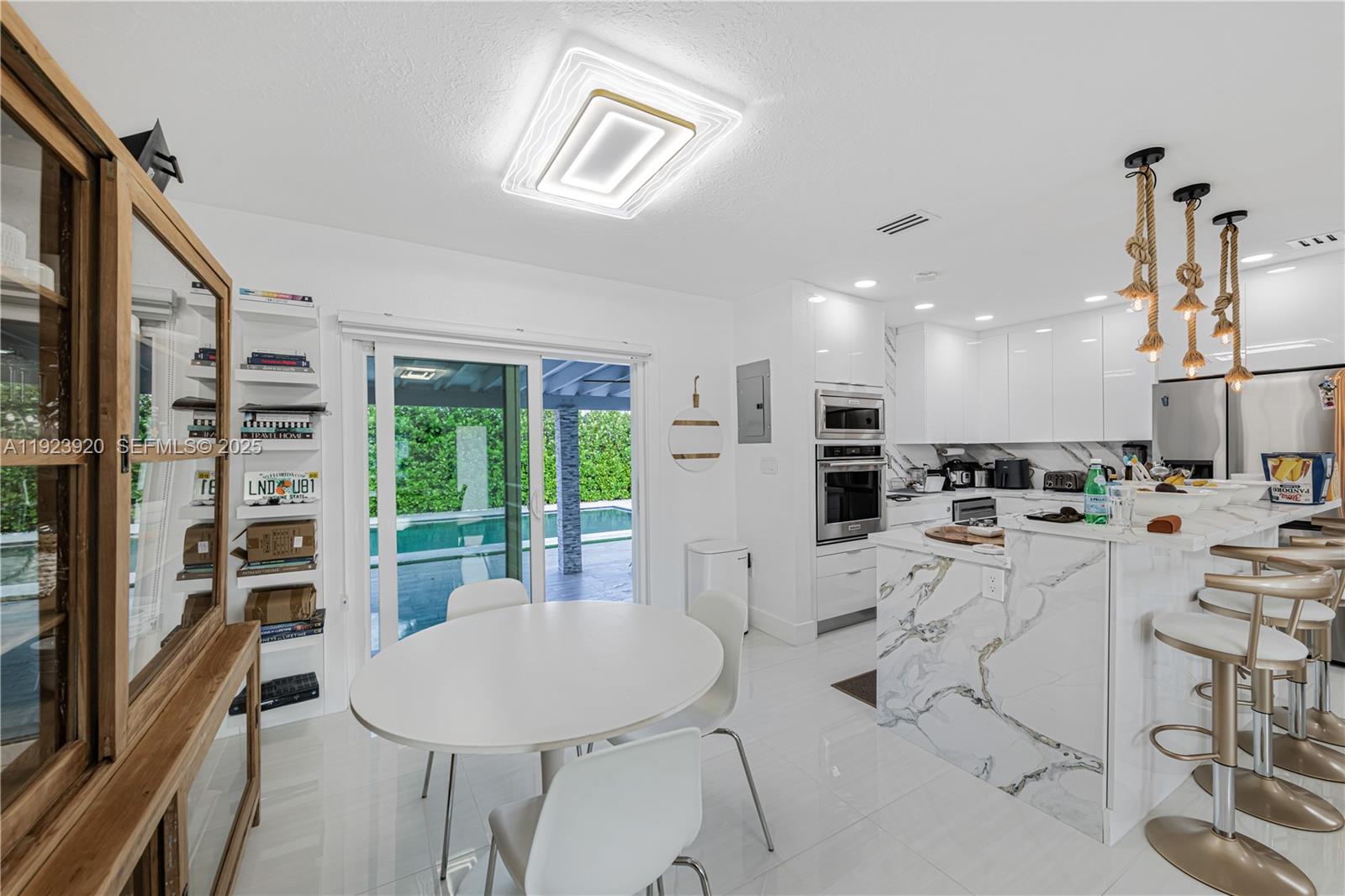 7235 Southwest 39th Street Miami, FL 33155 - Photo 6 of 30 a living room with furniture a large window and stainless steel appliances