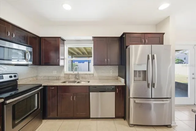 a kitchen with a refrigerator sink and microwave