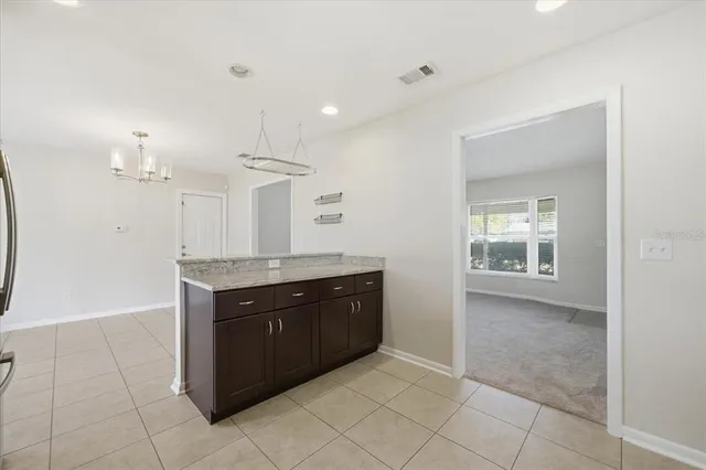 a view of kitchen with granite countertop cabinets and sink