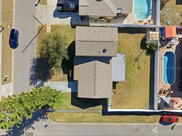 an aerial view of residential houses with outdoor space