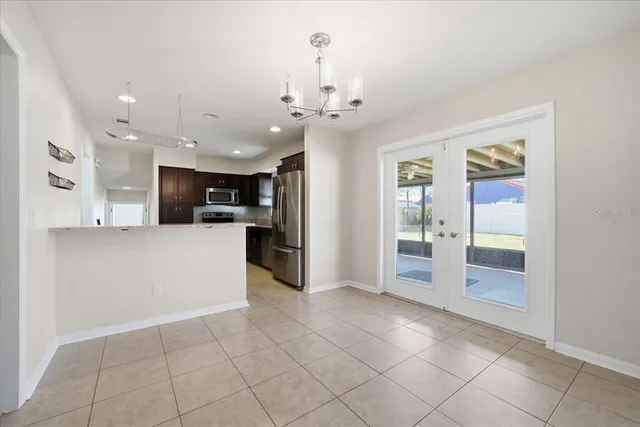 a view of a kitchen with a sink and a refrigerator