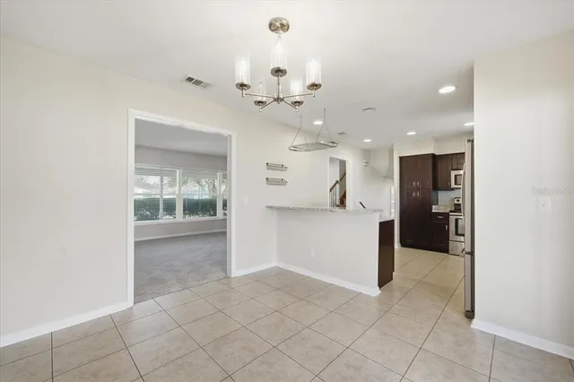 a view of a kitchen with a sink and refrigerator