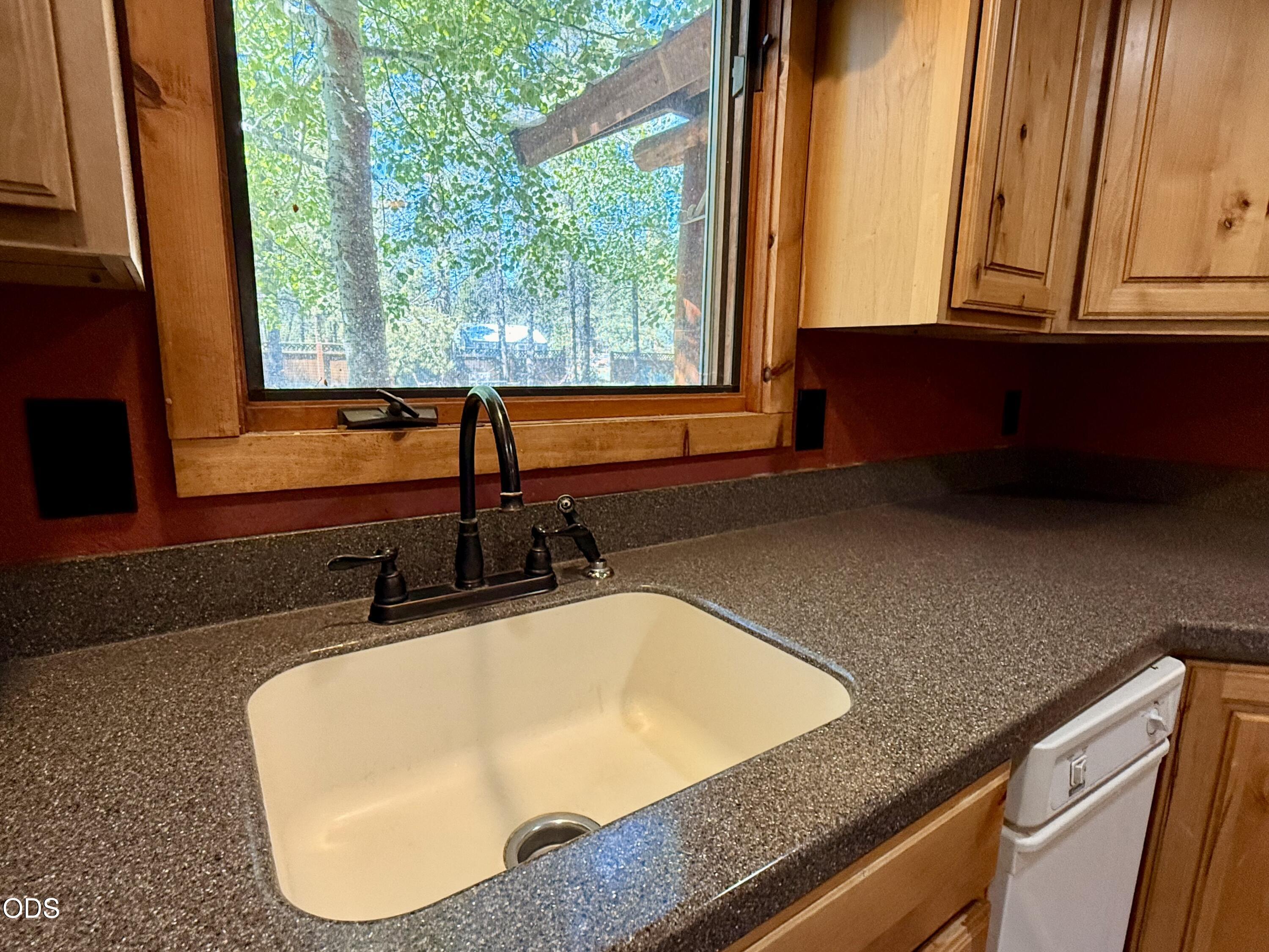 16025 Strawn Road La Pine, OR 97739 - Photo 23 of 95 a bathroom with a granite countertop sink and a large mirror next to a window