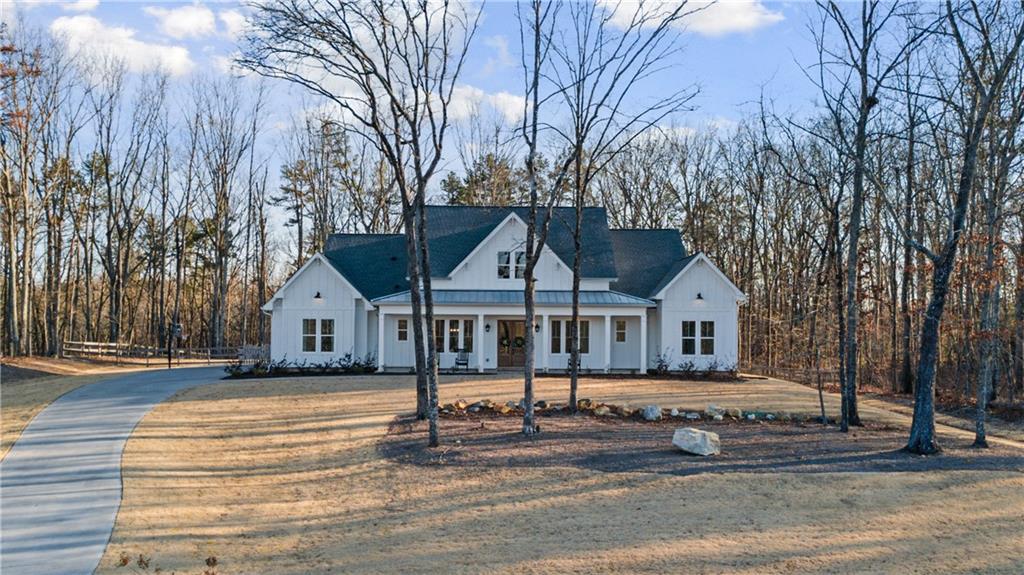 28 Cedar Gate Lane Kingston, GA 30145 - Photo 1 of 1 a front view of a house with a garden and trees