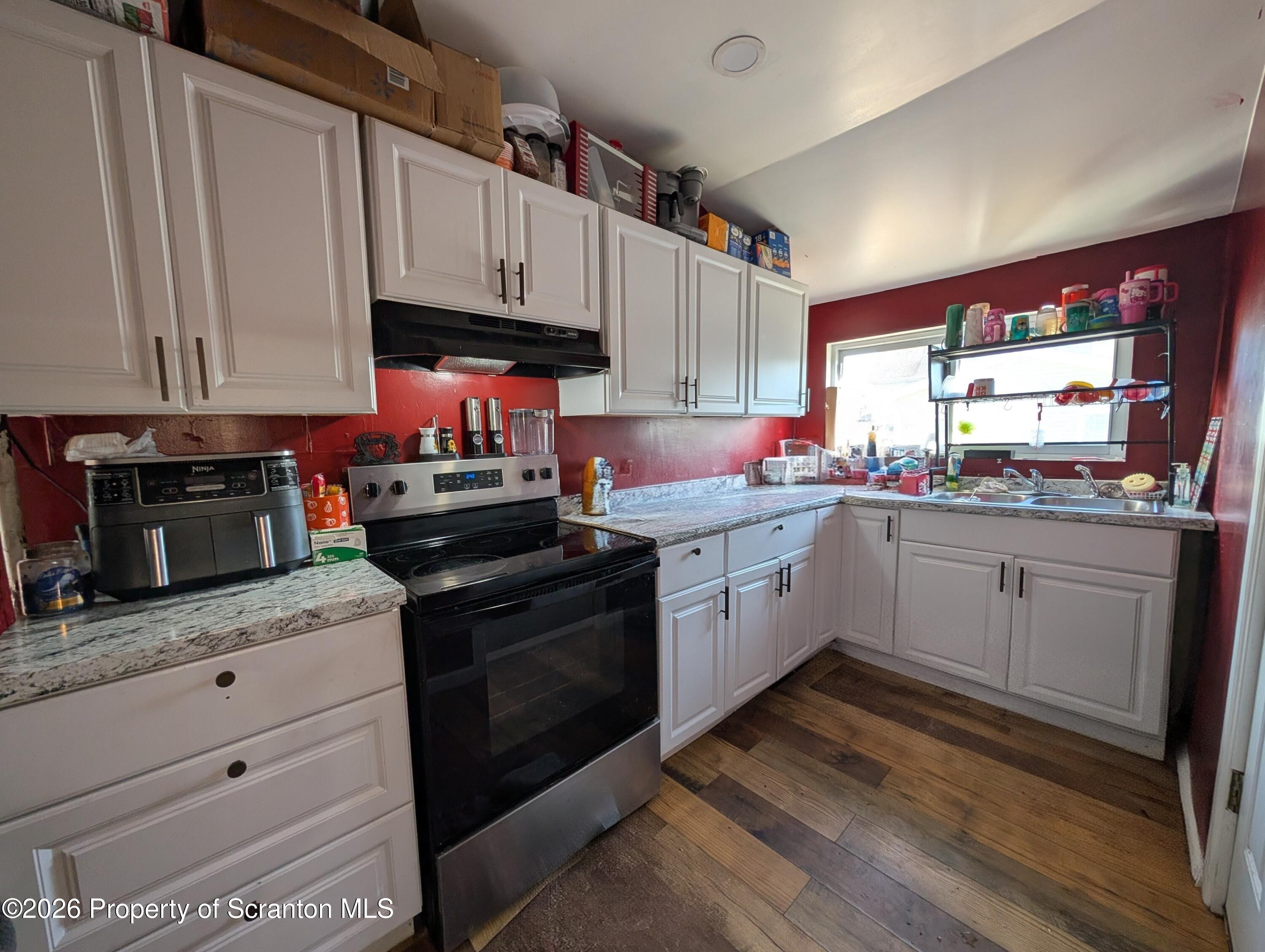 2402 North Main Avenue Scranton, PA 18508 - Photo 4 of 16 a kitchen with granite countertop a sink stainless steel appliances and cabinets