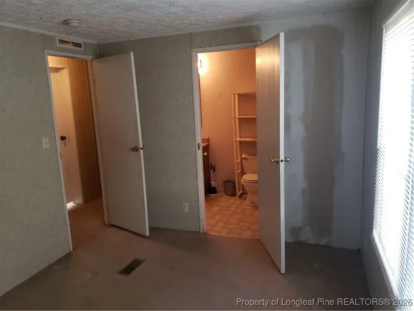 a bed sitting in a bedroom next to a window