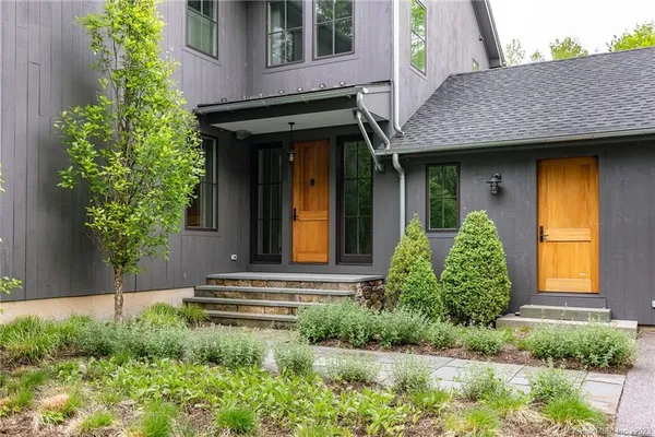 a front view of a house with garden