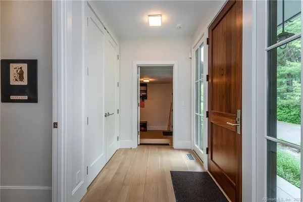 a view of a hallway with wooden floor