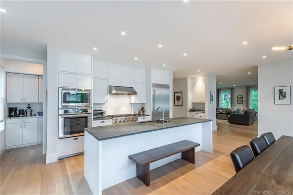 a large kitchen with stainless steel appliances lots of counter space and a sink