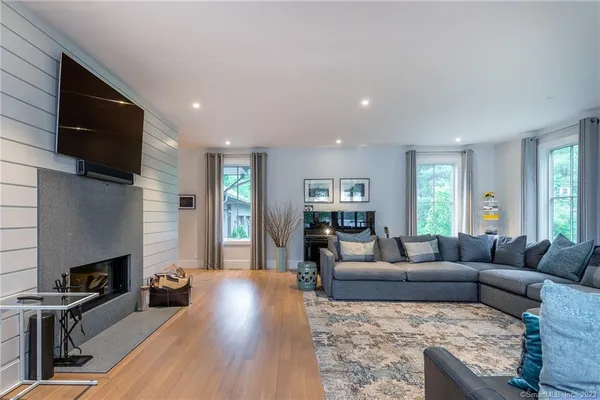 a living room with fireplace furniture and a flat screen tv