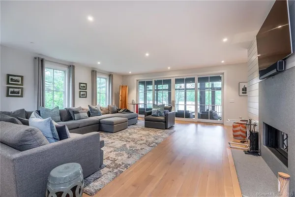 a living room with furniture fireplace and a flat screen tv