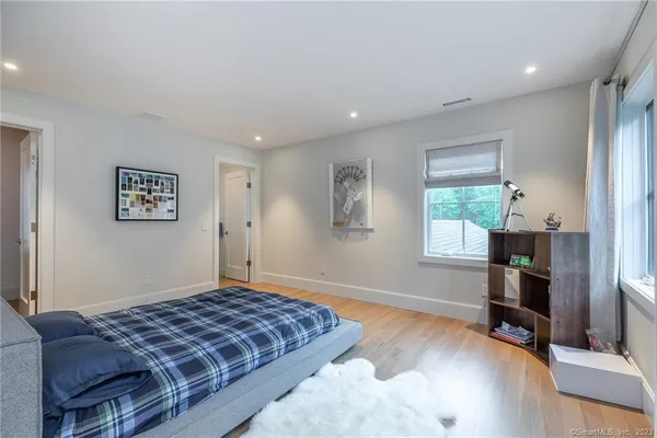 a bedroom with a bed and a window