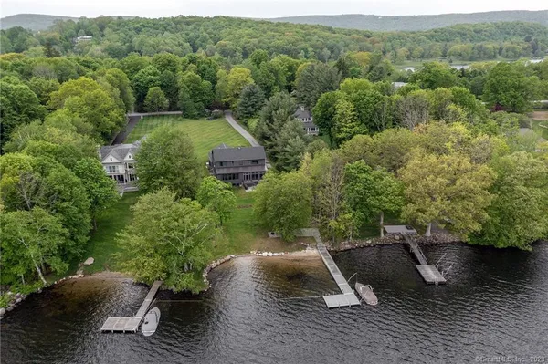 an aerial view of a house with pool outdoor seating and yard