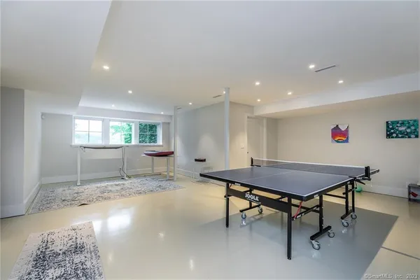 a room with furniture pool table and windows