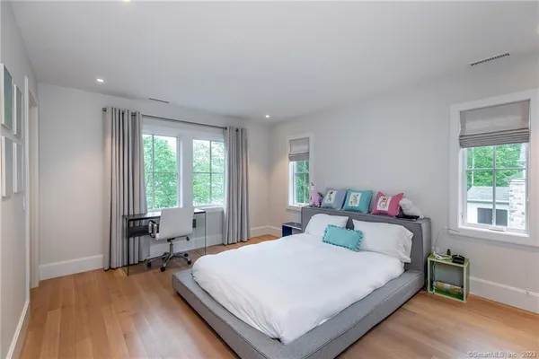 a bedroom with a bed and a large window