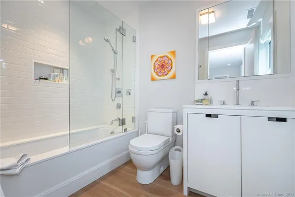 a bathroom with a sink a toilet and shower