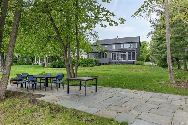 a view of a house with backyard sitting area and garden