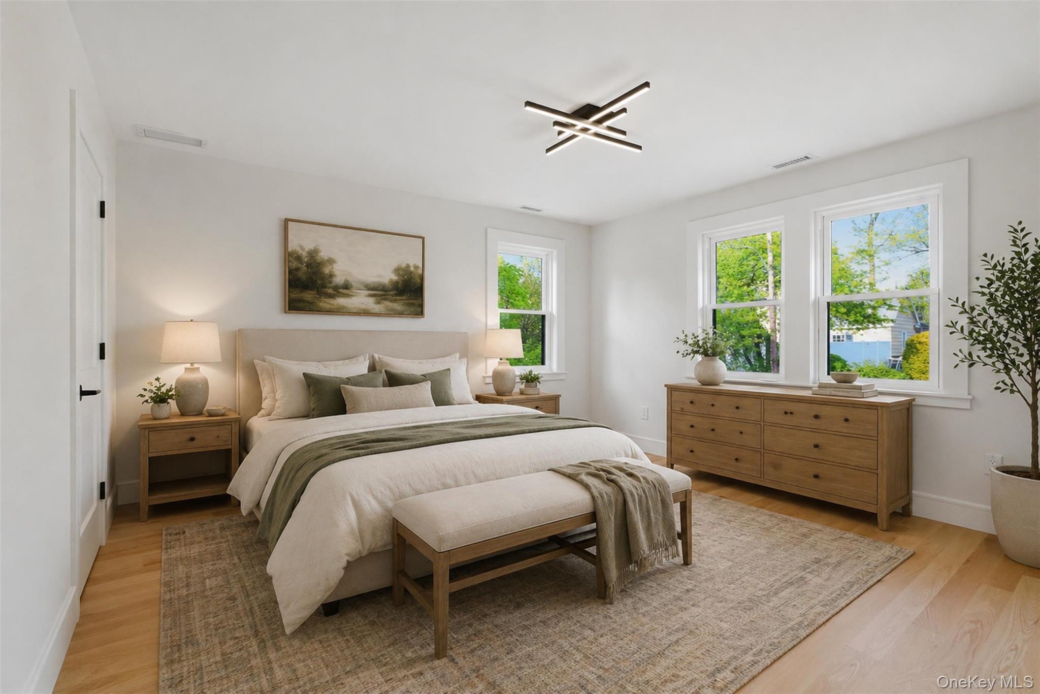 40 Calhoun Avenue New Rochelle, NY 10801 - Photo 20 of 49 Bright bedroom featuring wood-finish flooring, white walls, and multiple double-hung windows