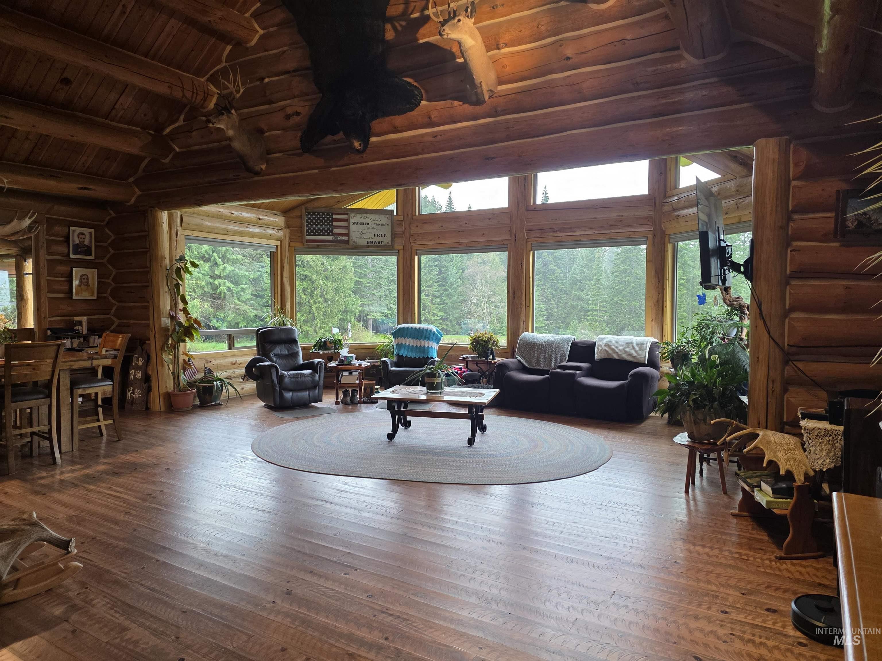 112 Three Forks Road Kamiah, ID 83536 - Photo 10 of 45 Expansive living space featuring wood-finish flooring and a full wall of large windows