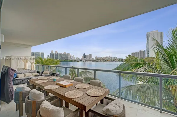 a balcony with furniture and wooden floor