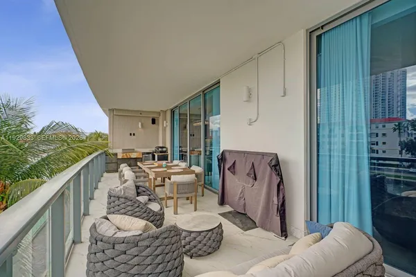 a view of balcony with outdoor seating and city view