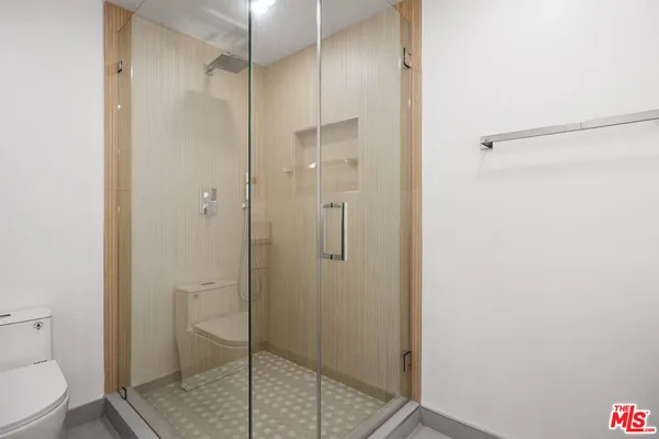a bathroom with a shower and toilet
