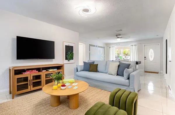 a living room with furniture and a flat screen tv