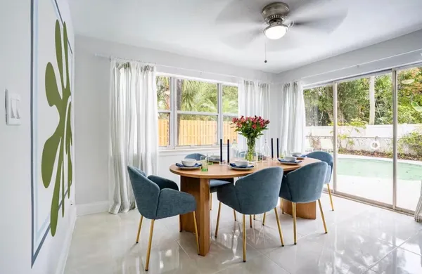 a dining room with furniture a rug and a chandelier