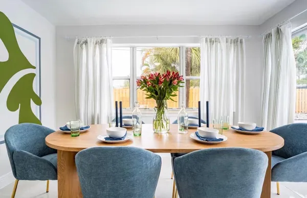 a dining room with furniture and window
