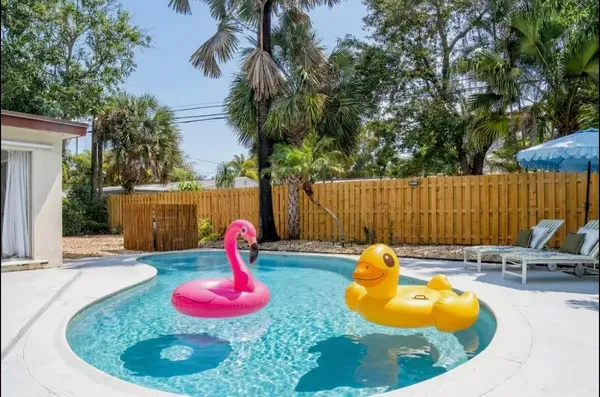 a swimming pool with yard and outdoor seating