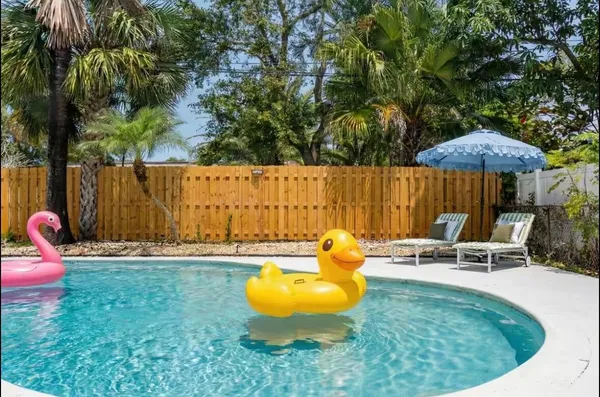 a swimming pool with outdoor seating and yard
