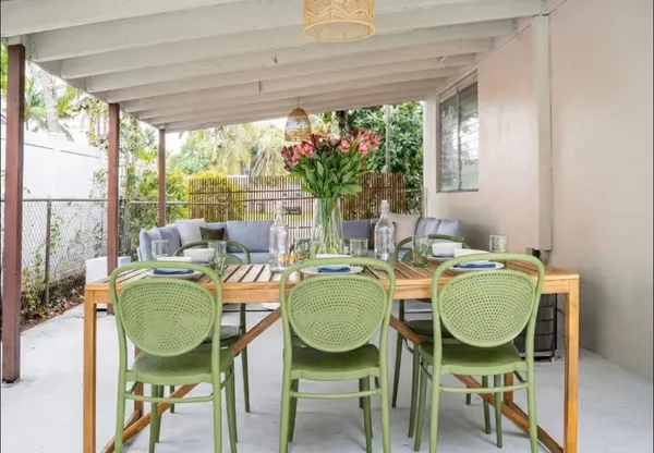 a dining room with furniture and a window