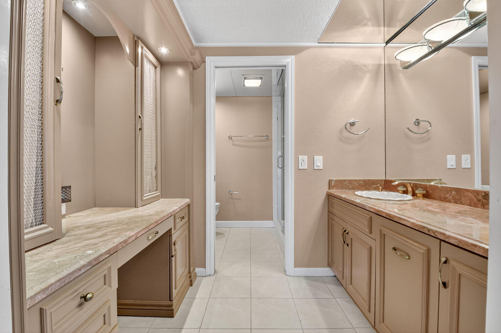 900 Greensward Lane, Unit 101G Delray Beach, FL 33445 - Photo 23 of 62 a spacious bathroom with a granite countertop sink a mirror and a shower