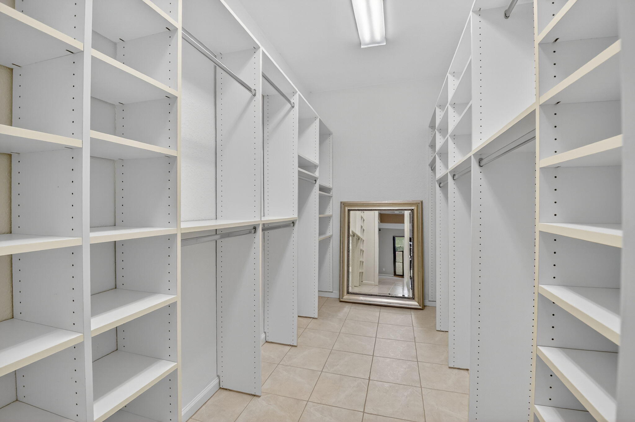 900 Greensward Lane, Unit 101G Delray Beach, FL 33445 - Photo 27 of 62 a view of walk in closet with empty racks