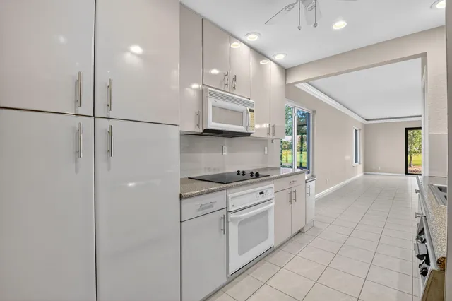 a bathroom with a granite countertop sink a toilet a mirror and shower