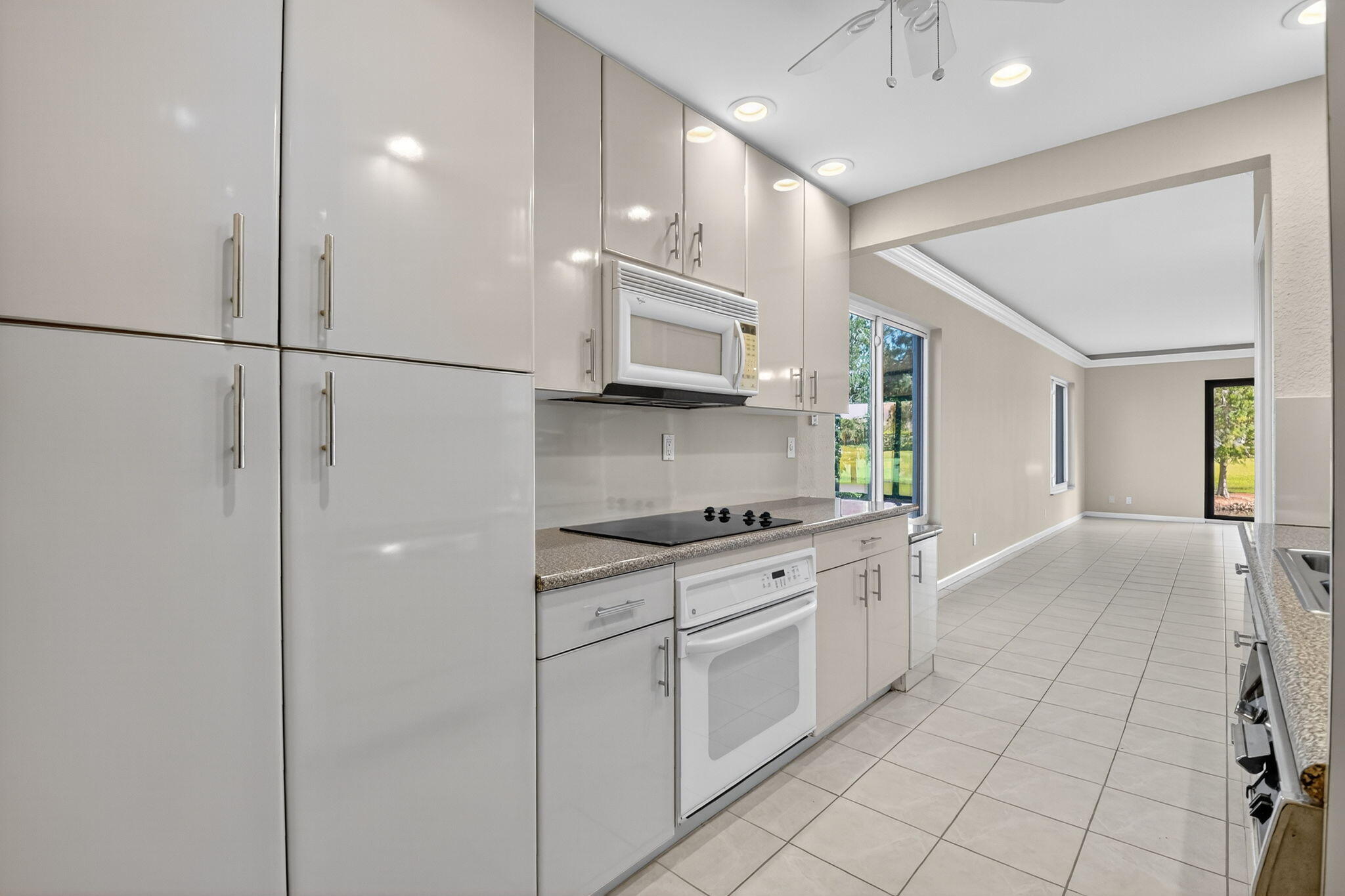 900 Greensward Lane, Unit 101G Delray Beach, FL 33445 - Photo 29 of 62 a kitchen with stainless steel appliances granite countertop a stove a sink and a refrigerator