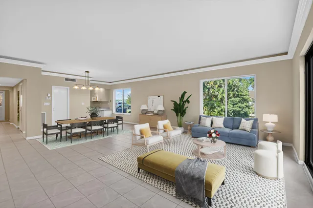 a living room with furniture a flat screen tv and a large window