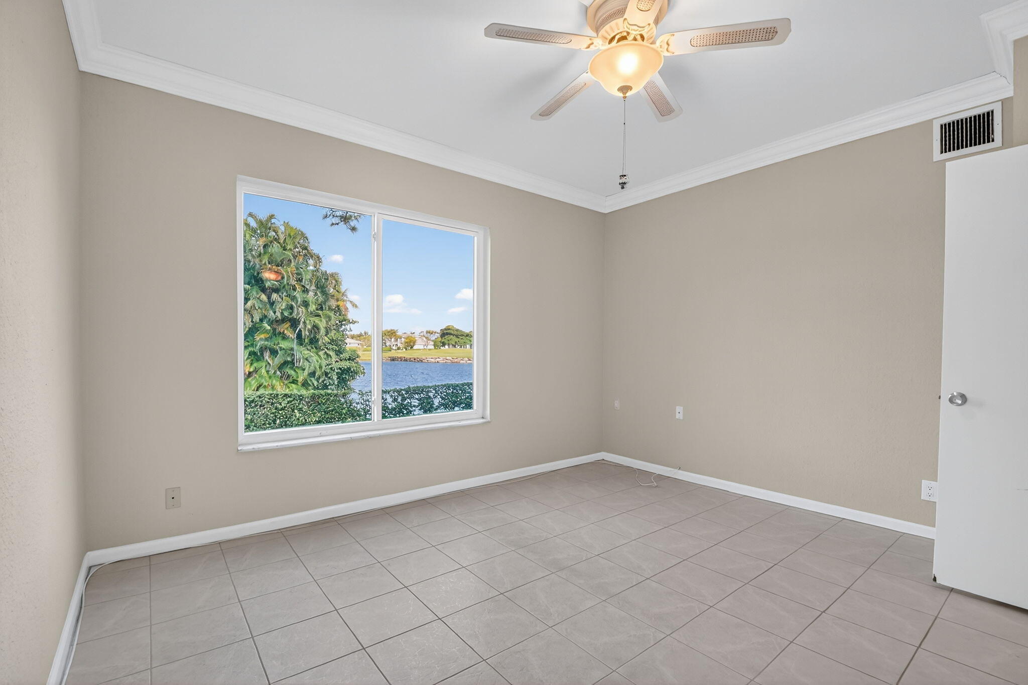 900 Greensward Lane, Unit 101G Delray Beach, FL 33445 - Photo 33 of 62 an empty room with windows and chandelier fan