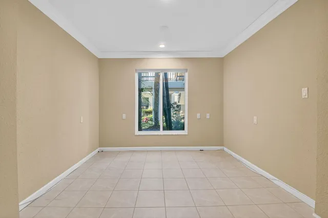 an aerial view of a residential houses with outdoor space and trees