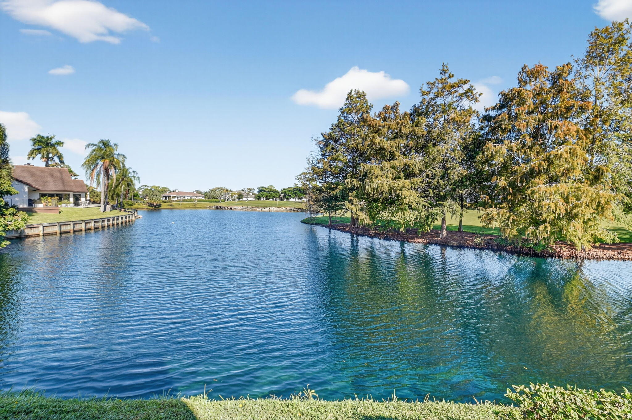 900 Greensward Lane, Unit 101G Delray Beach, FL 33445 - Photo 45 of 62 a view of an ocean with boats and trees in the background