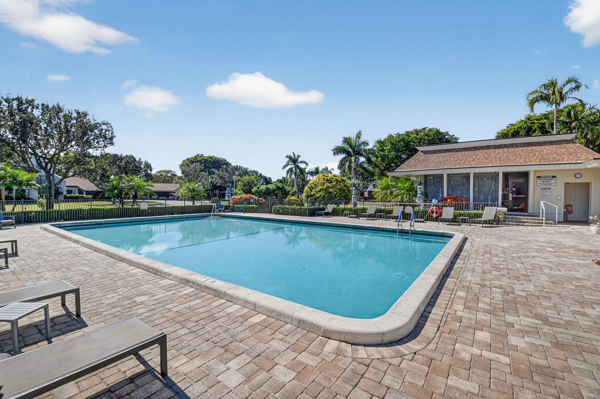 900 Greensward Lane, Unit 101G Delray Beach, FL 33445 - Photo 50 of 62 a view of swimming pool and lounge chair