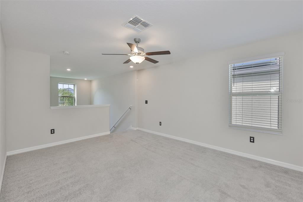 797 Olive Conch Street Ruskin, FL 33570 - Photo 15 of 53 an empty room with a window and a fan
