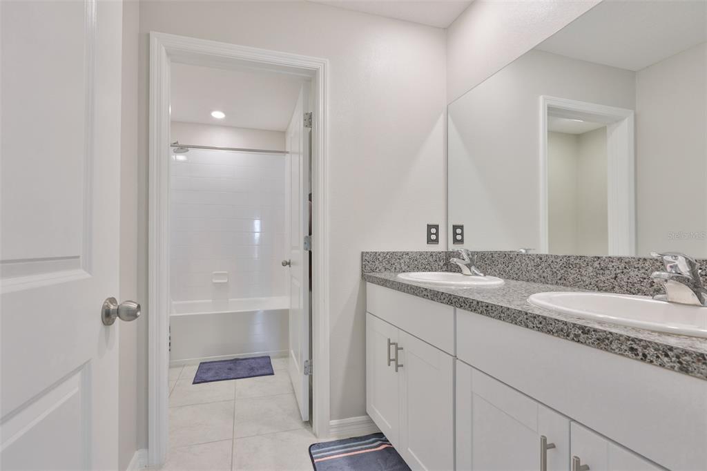 797 Olive Conch Street Ruskin, FL 33570 - Photo 22 of 53 a bathroom with a granite countertop sink and a mirror