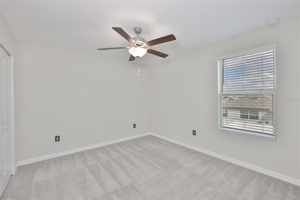 797 Olive Conch Street Ruskin, FL 33570 - Photo 25 of 53 an empty room with a window and a fan