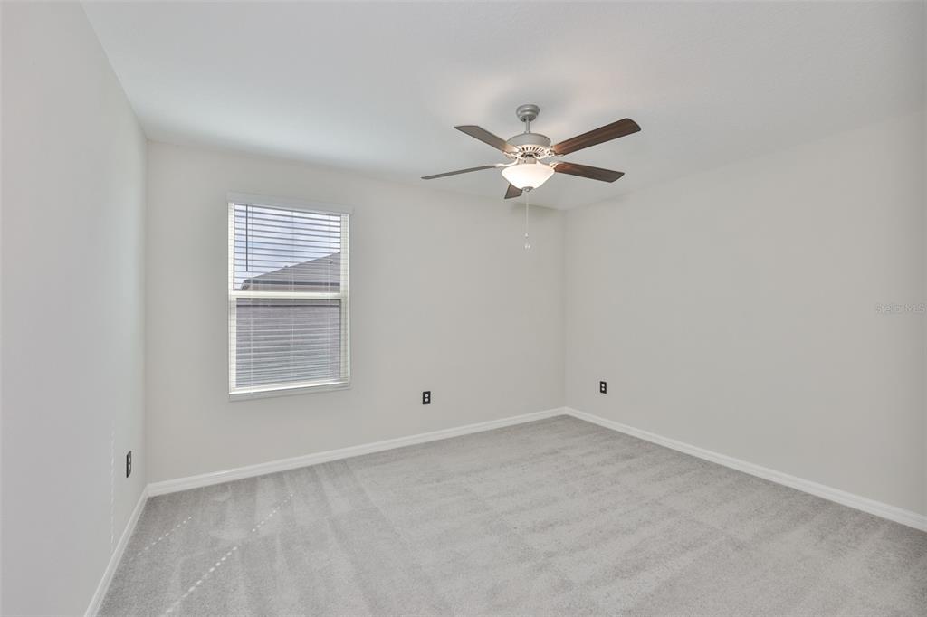 797 Olive Conch Street Ruskin, FL 33570 - Photo 26 of 53 an empty room with a window and a fan