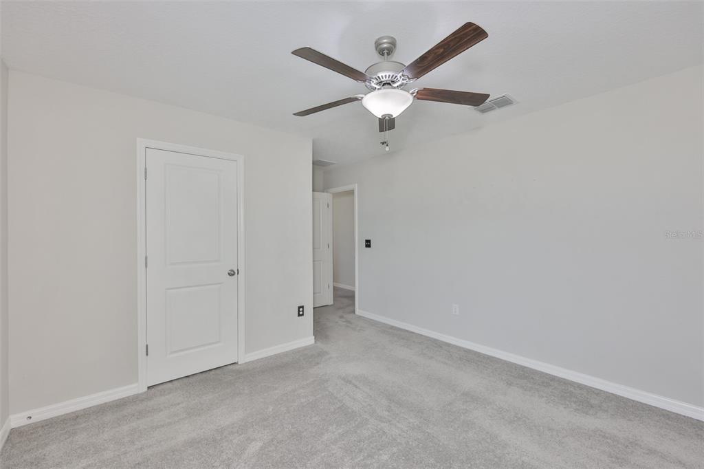 797 Olive Conch Street Ruskin, FL 33570 - Photo 28 of 53 an empty room with a fan and a fan