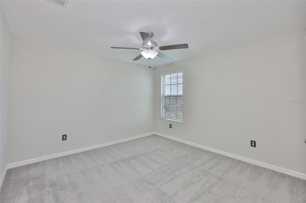 797 Olive Conch Street Ruskin, FL 33570 - Photo 29 of 53 an empty room with a window and a fan