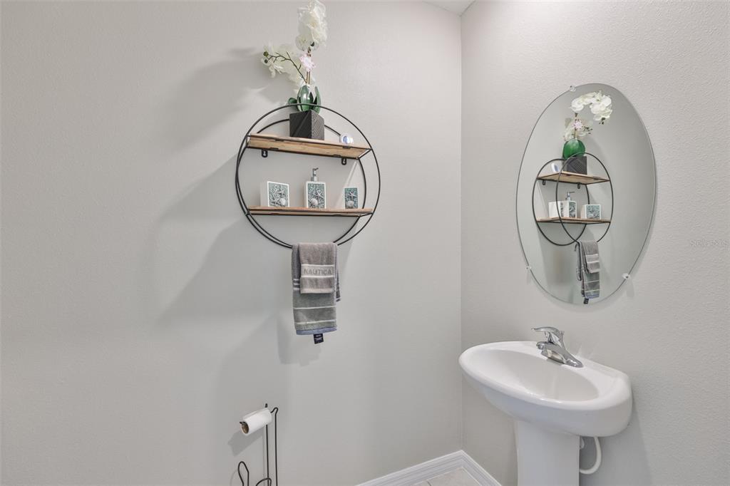 797 Olive Conch Street Ruskin, FL 33570 - Photo 30 of 53 a bathroom with a sink and a mirror